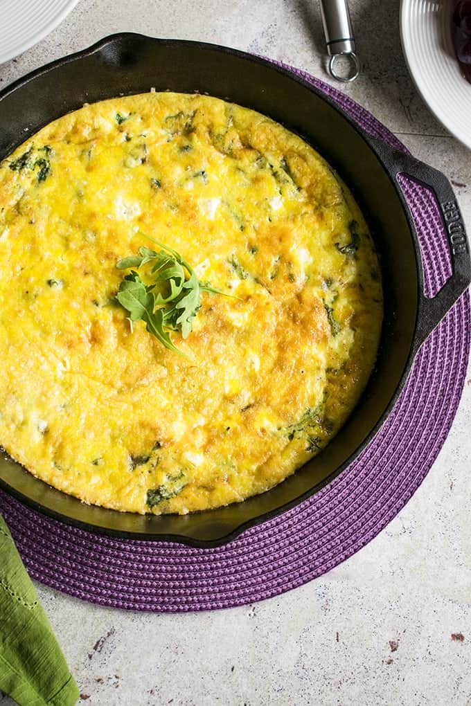 baked arugula frittata in iron skillet