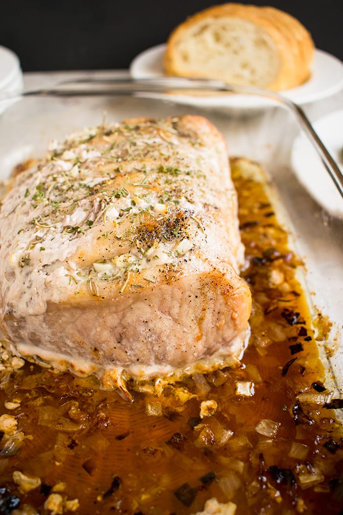 close-up of Roasted Pork Loin with Rosemary and Garlic in a pan