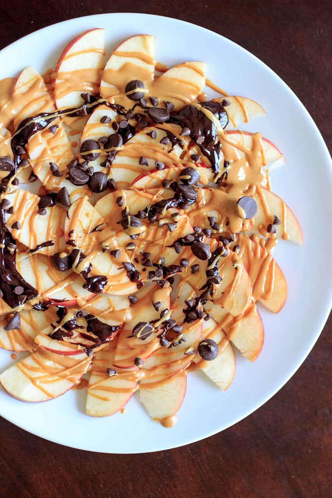 overhead view of Apple Nachos with Peanut Butter and Chocolate on a plate