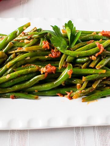 close-up of Italian green beans with tomatoes on a platter