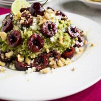 close-up of guacamole with cherries, gorgonzola and walnuts in a bowl