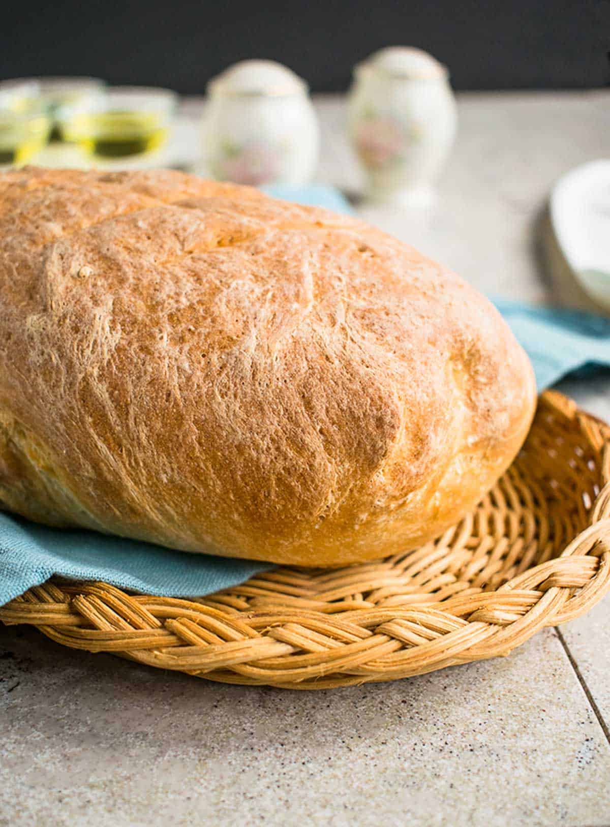 loaf of bread on basket, blue napkin