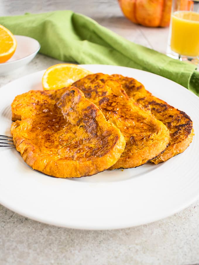 three pieces of pumpkin-orange french toast on plate