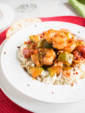 Shrimp stew with bacon, zucchini, tomatoes and rice in a bowl