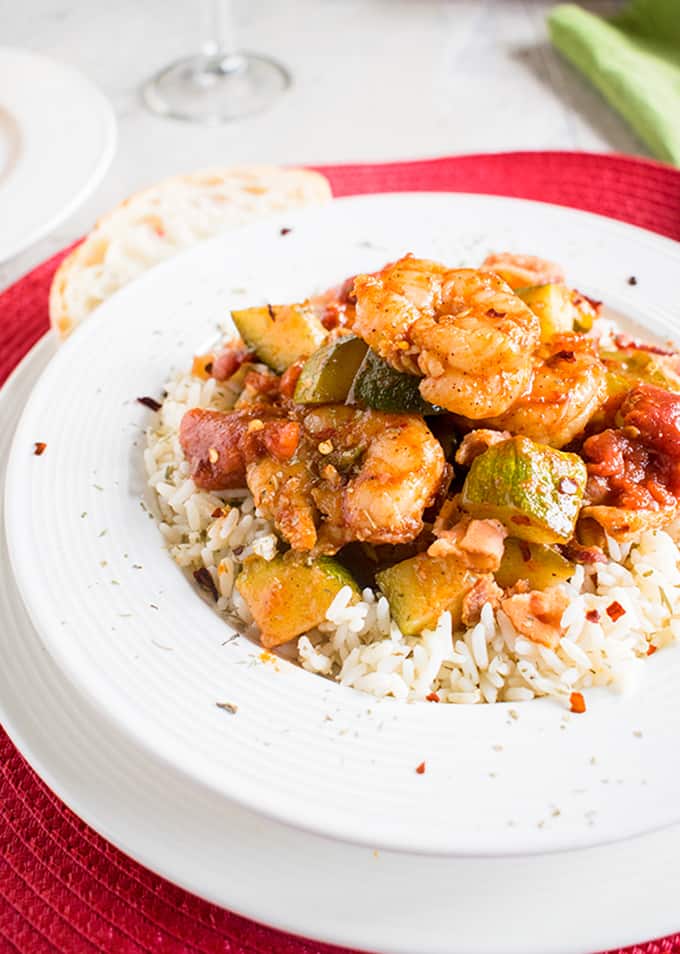 Shrimp stew with bacon, zucchini, tomatoes and rice in a bowl