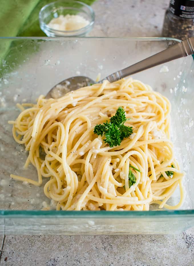 pasta with pecorino and pepper in a glass container with a spoon