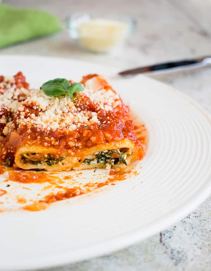 a slice of homemade manicotti on a plate