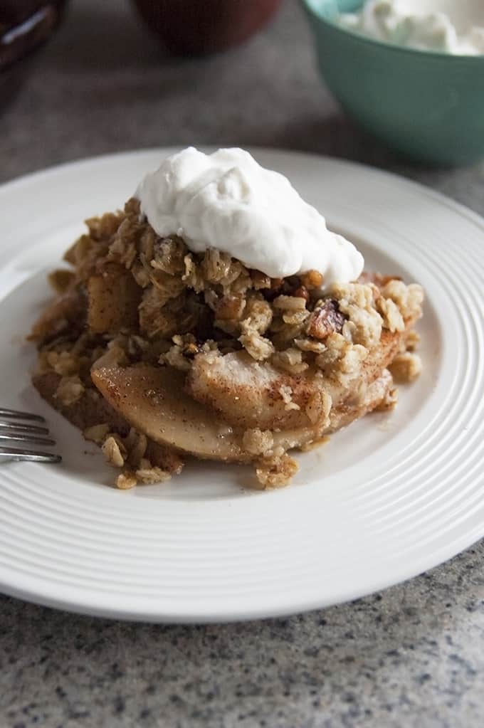 gluten-free pear crisp in a bowl with a fork