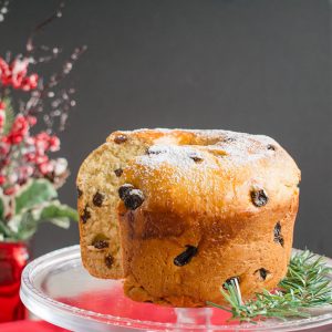 panettone bread with a slice cut out on a cake stand
