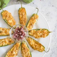 overhead photo of baked parmesan jalapeno poppers with prosciutto on a plate