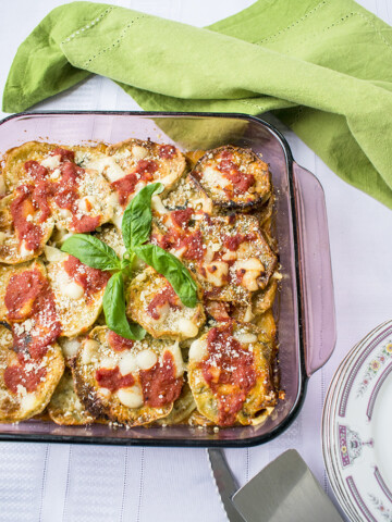 cooked eggplant parmigiana in a glass container