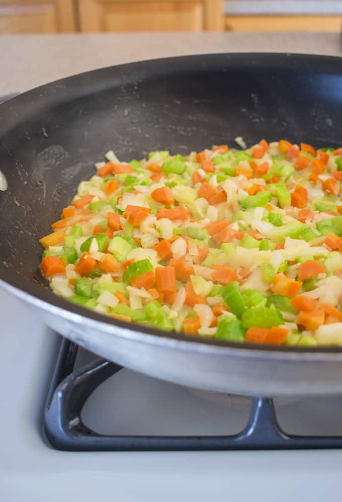 a blend of chopped onions, carrots and celery in a frying pan