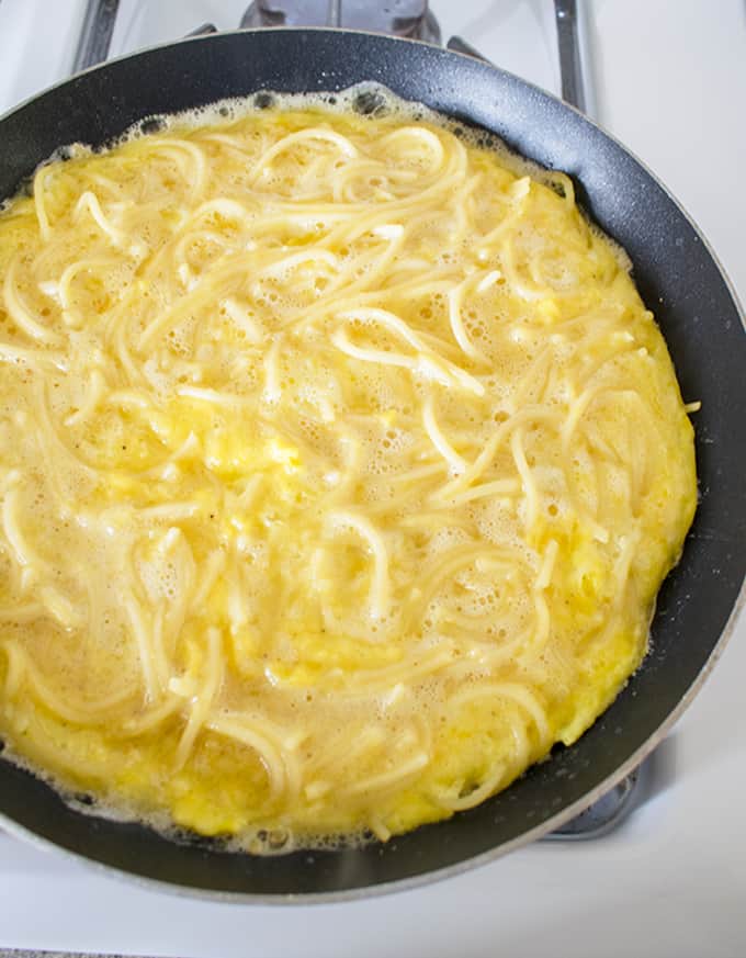 Leftover Spaghetti Frittata Cooking in a pan on the Stove