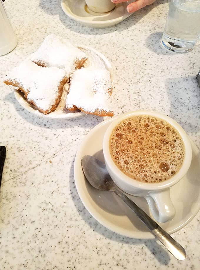 Beignets and Cafe au Lait from Cafe du Monde in New Orleans - New Orleans Restaurants and Highlights from Our Trip #neworleans #neworleanstravel #nola 