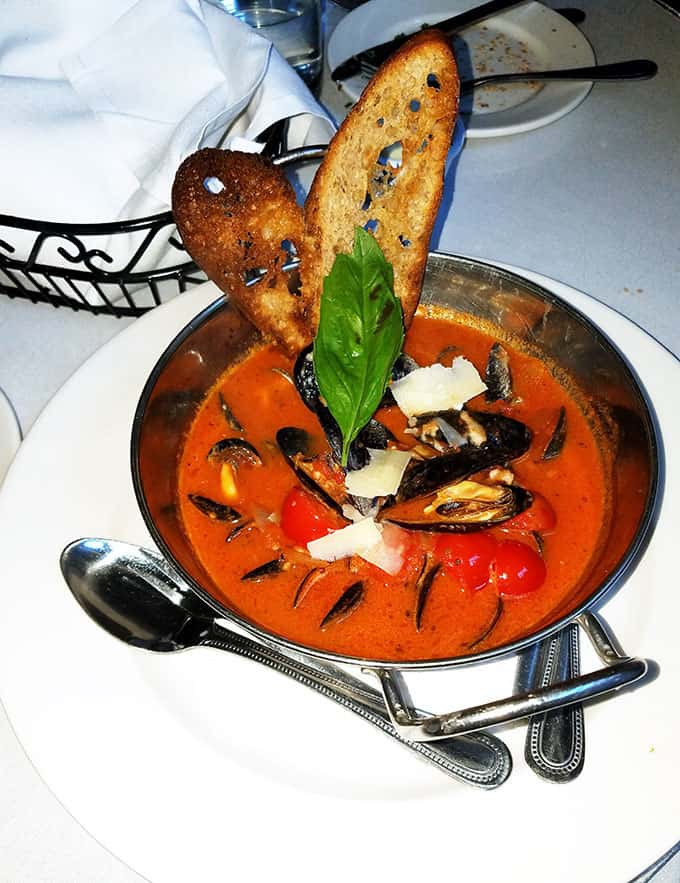 Mussels in Tomato Sauce with two pieces of toasted bread in a bowl from Irene\'s Cuisine in New Orleans