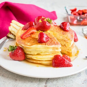 stack of lemon ricotta pancakes with strawberries