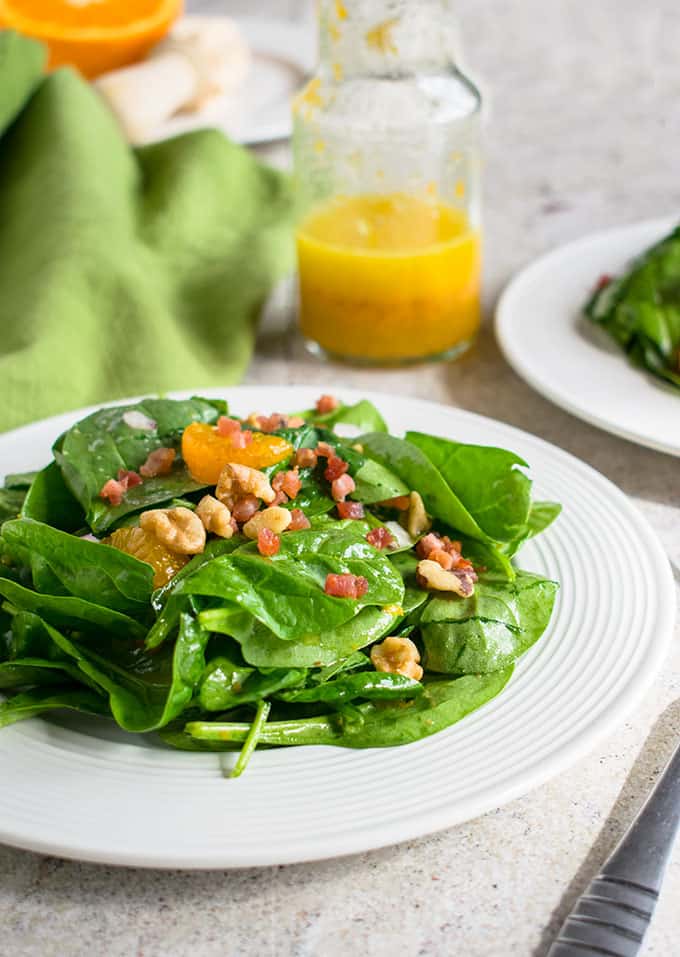 Photo of plate of Spinach Salad with Mandarin Oranges and Pancetta and bottle or orange vinaigrette