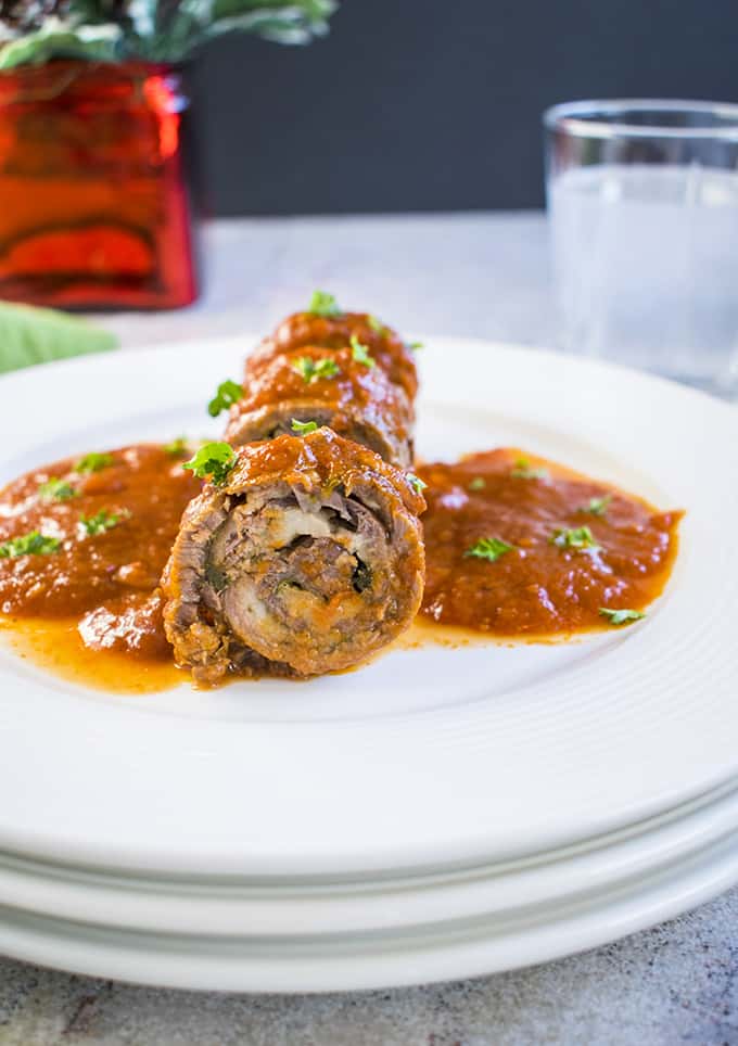 Photo of sliced braciole on plate with tomato sauce