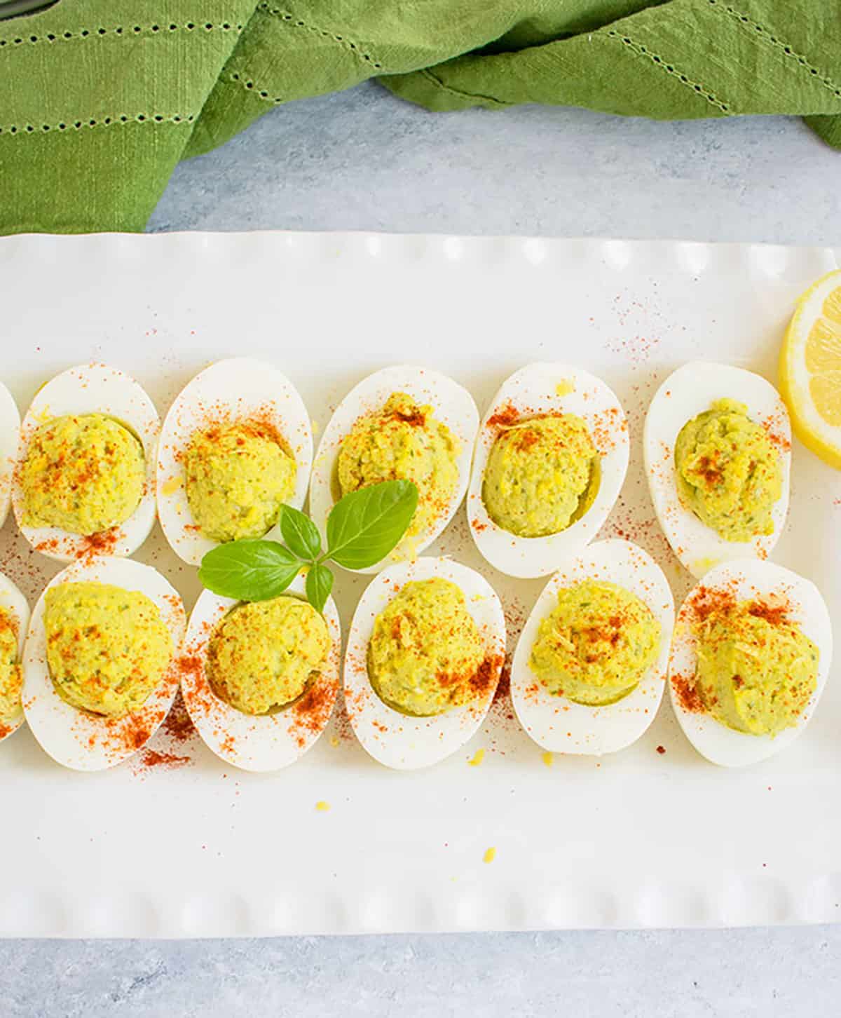 Overhead photo of pesto deviled eggs on a platter