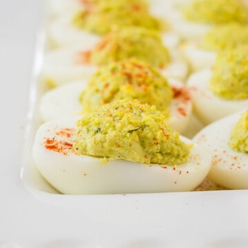close-up photo of pesto deviled eggs on a platter