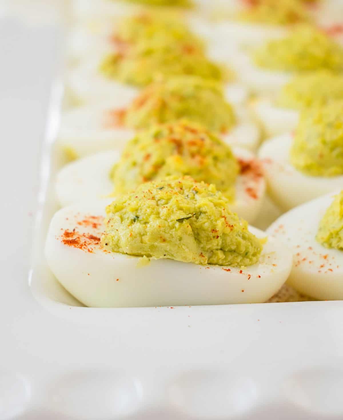 close-up photo of pesto deviled eggs on a platter