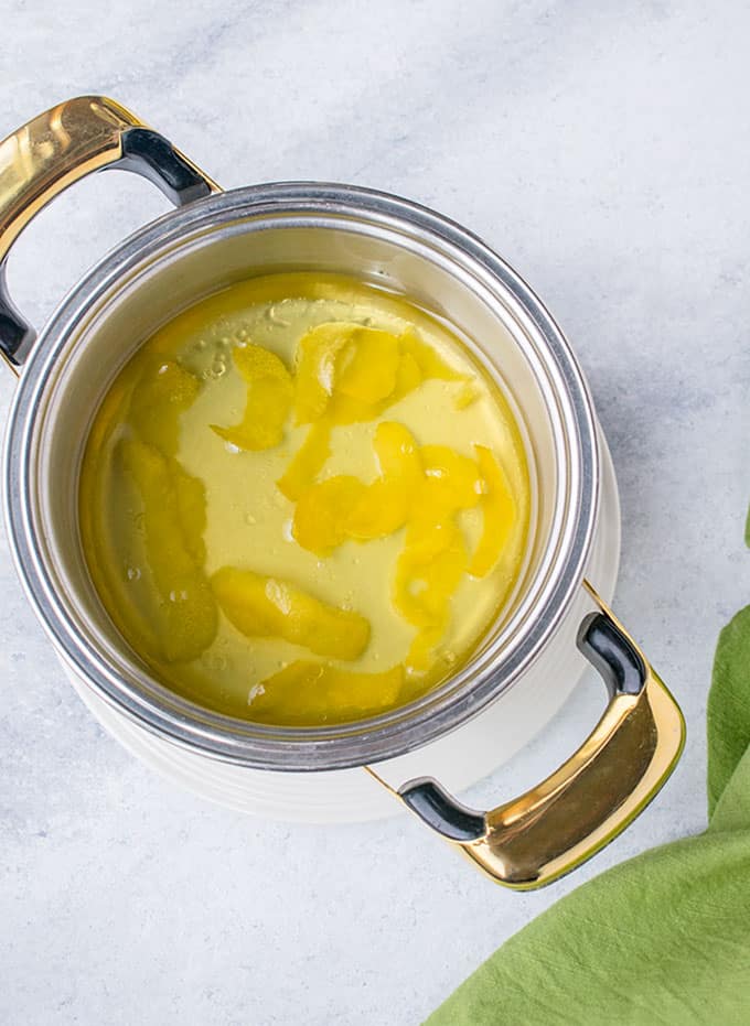 pot of olive oil with lemon peels