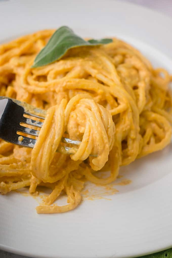 forkful of twirled linguine with creamy pumpkin sauce