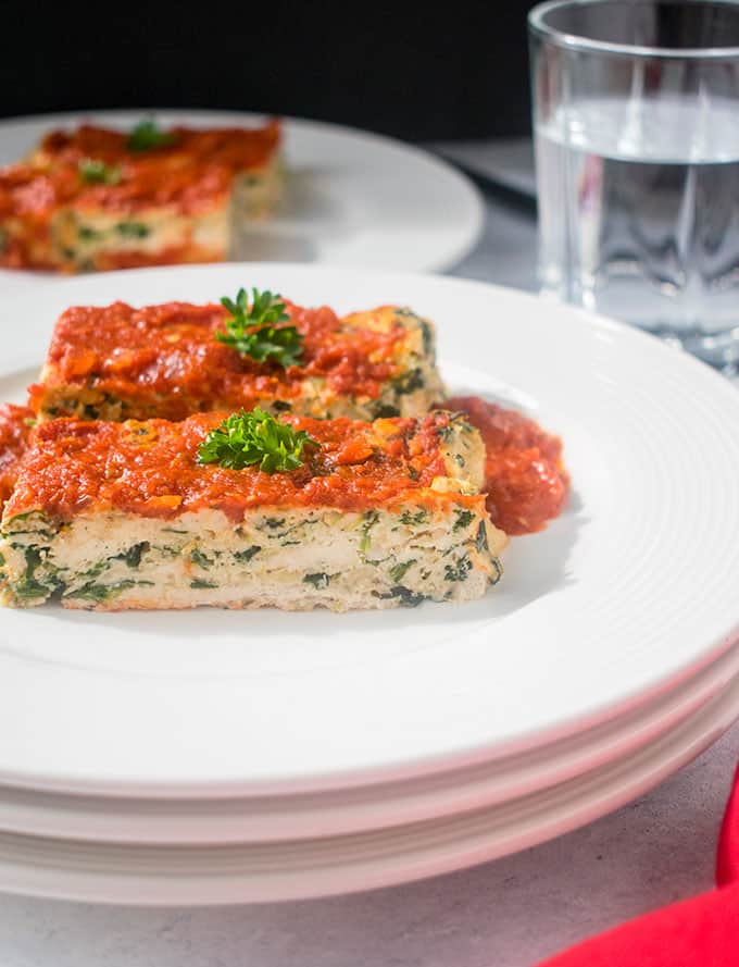 Two slices of Italian Meatloaf with chicken on stacked plates