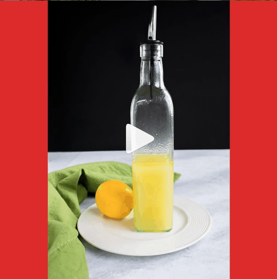 A tall bottle of lemon oil, lemon