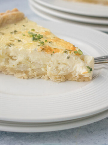slice of onion pie on plate with fork