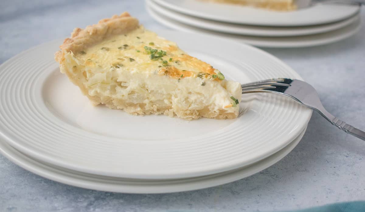 slice of onion pie on plate with fork