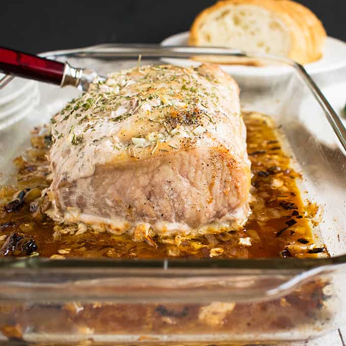 pork roast in pan with juices