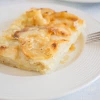 scalloped potatoes on white dish with fork