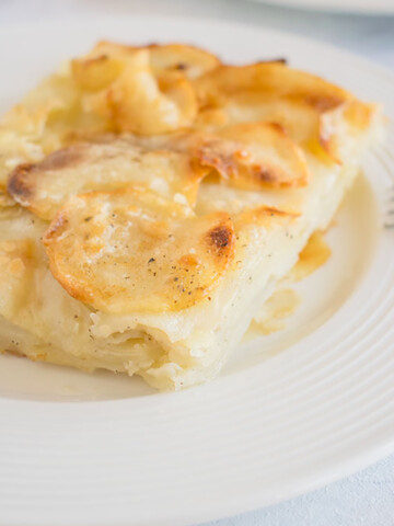 scalloped potatoes on white dish with fork