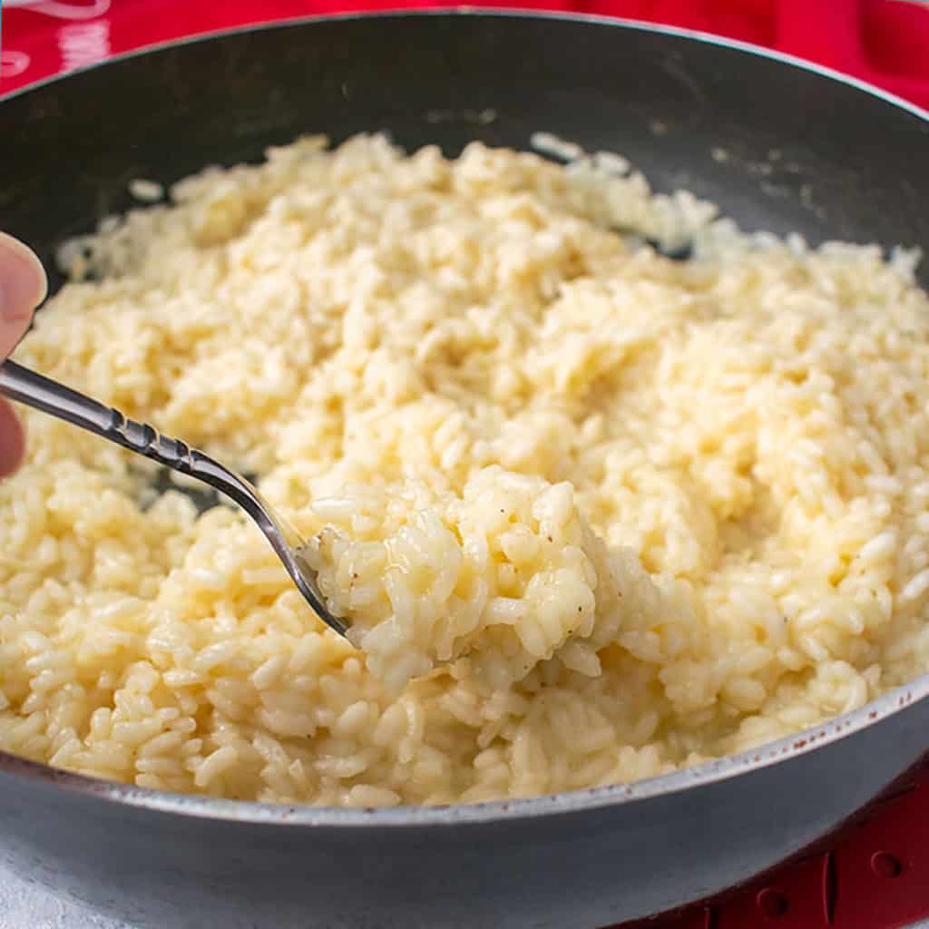forkful of creamy rice from pan