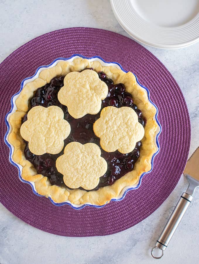whole blueberry pie topped with cookies