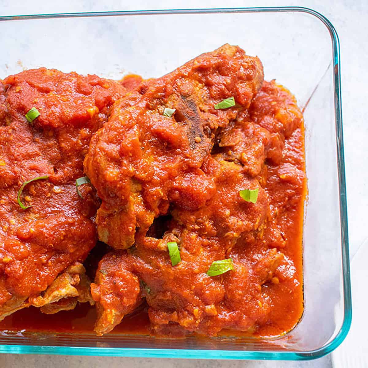 bowl of ribs with tomato sauce