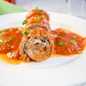 beef roll in tomato sauce on plate