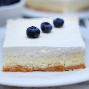 slice of square cheesecake with sour cream, blueberries