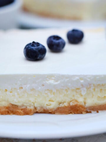 slice of square cheesecake with sour cream, blueberries