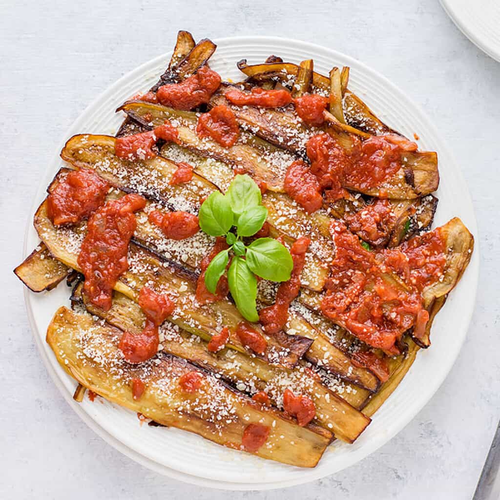 cooked eggplants with tomato sauce and basil