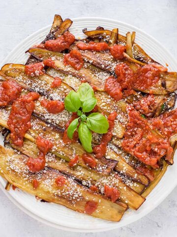 cooked eggplants with tomato sauce and basil