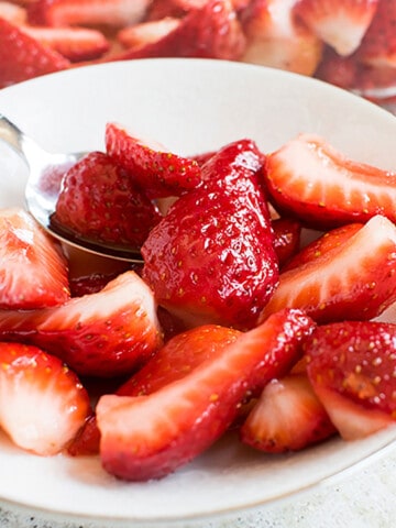 strawberries in small bowl with spoonful