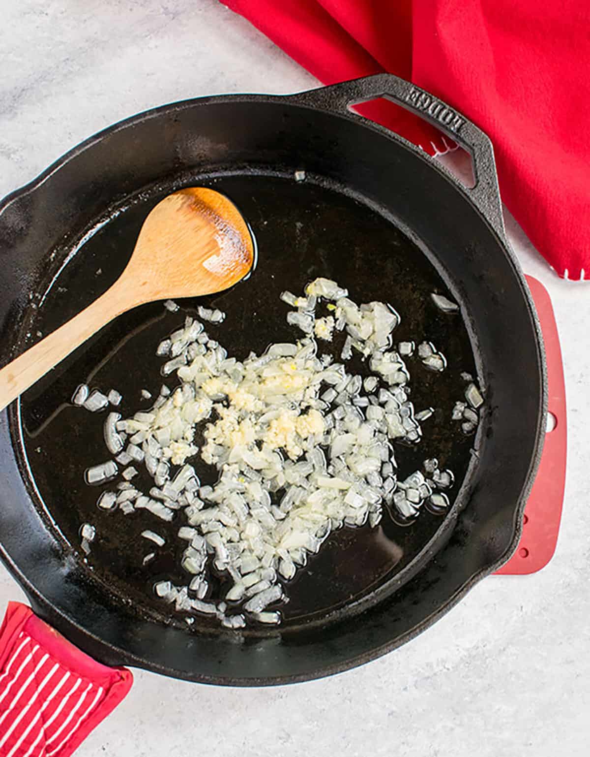 chopped onions in oil in cast iron pan