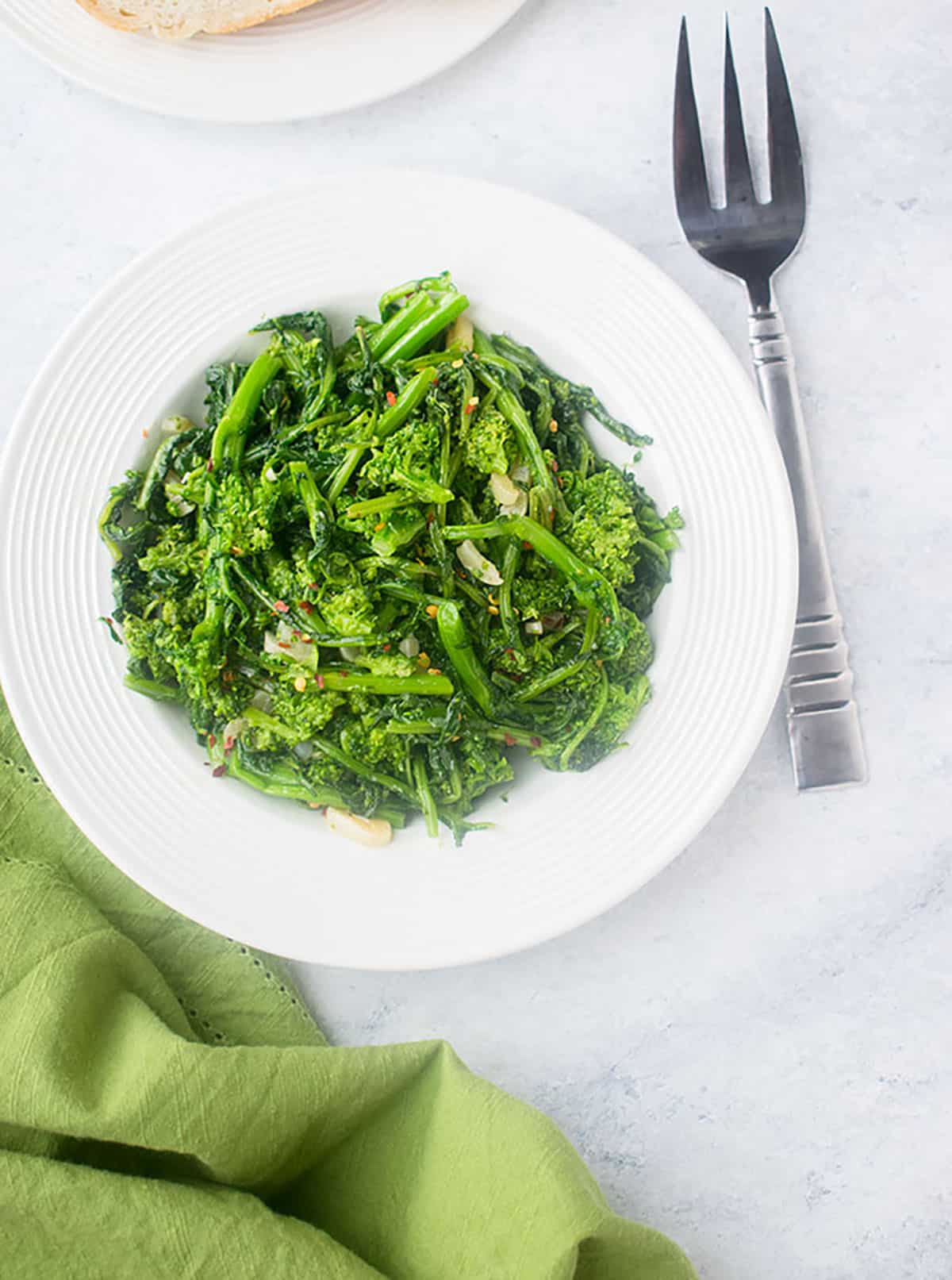 bowl of cooked rapini with serving fork