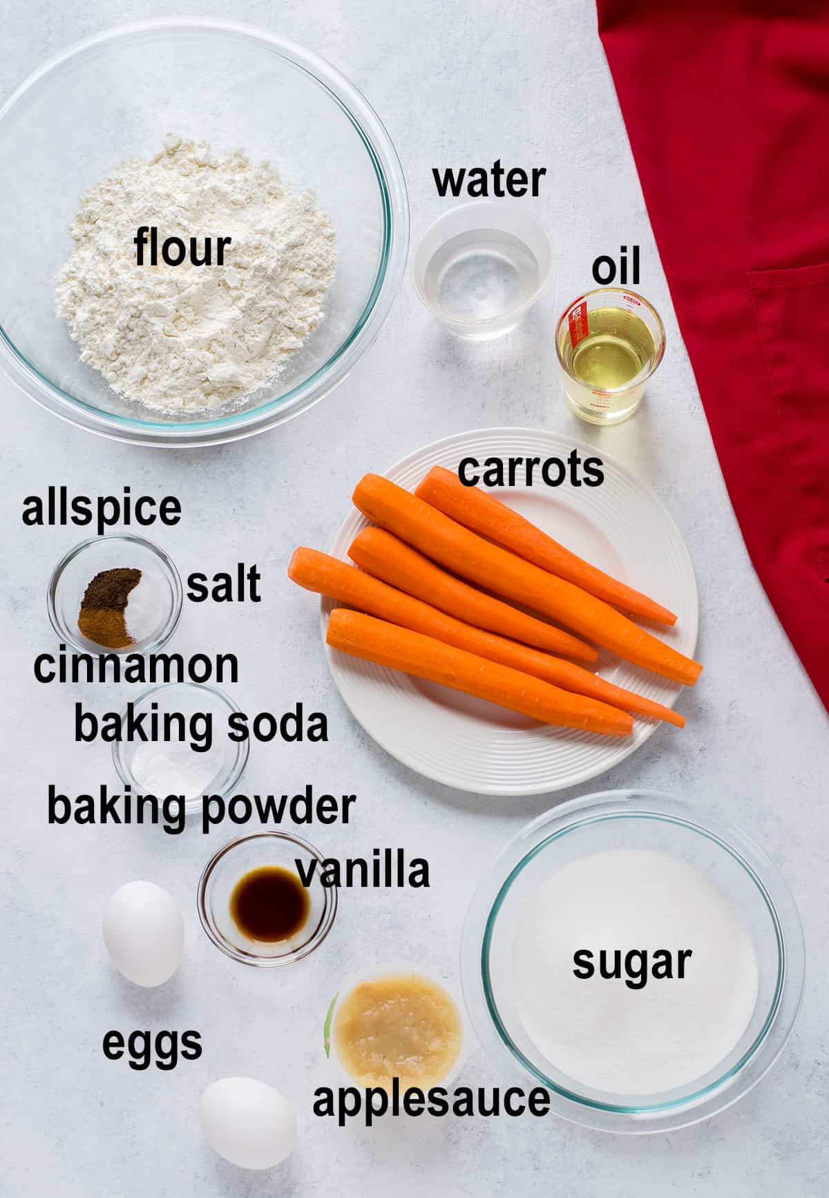 carrots, flour, sugar, oil, applesauce, water, spices, vanilla, baking powder, baking soda
