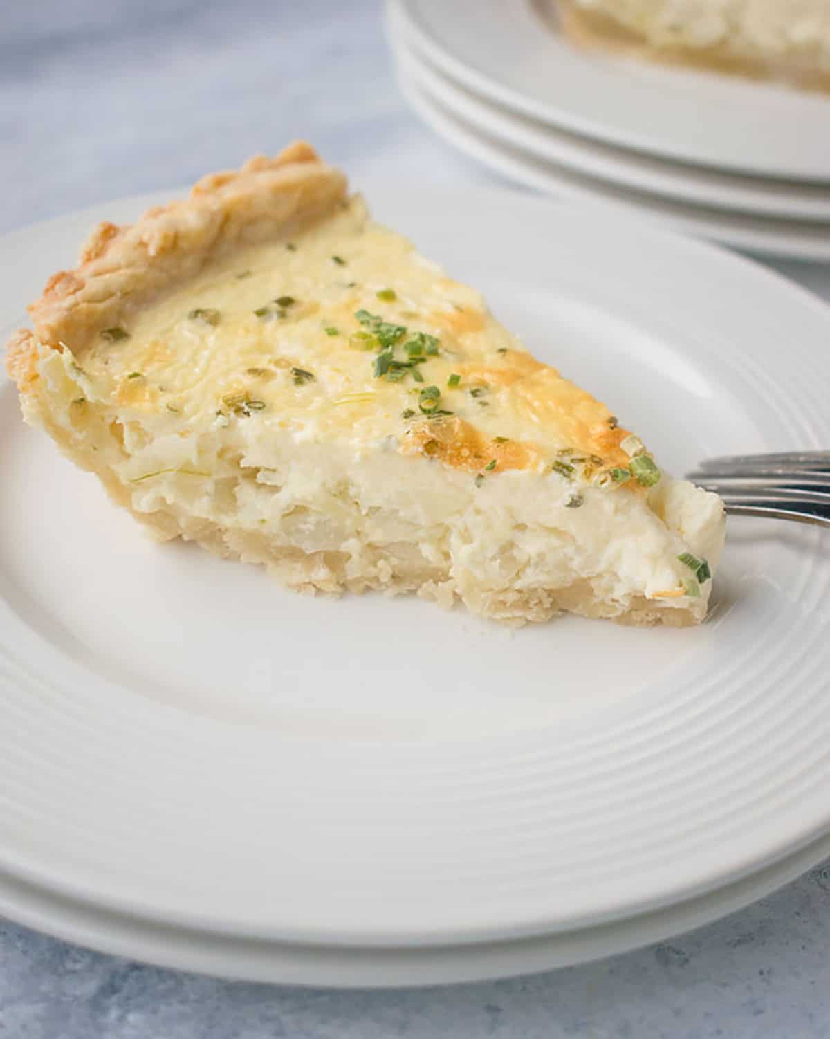 slice of savory pie with onions and cream cheese