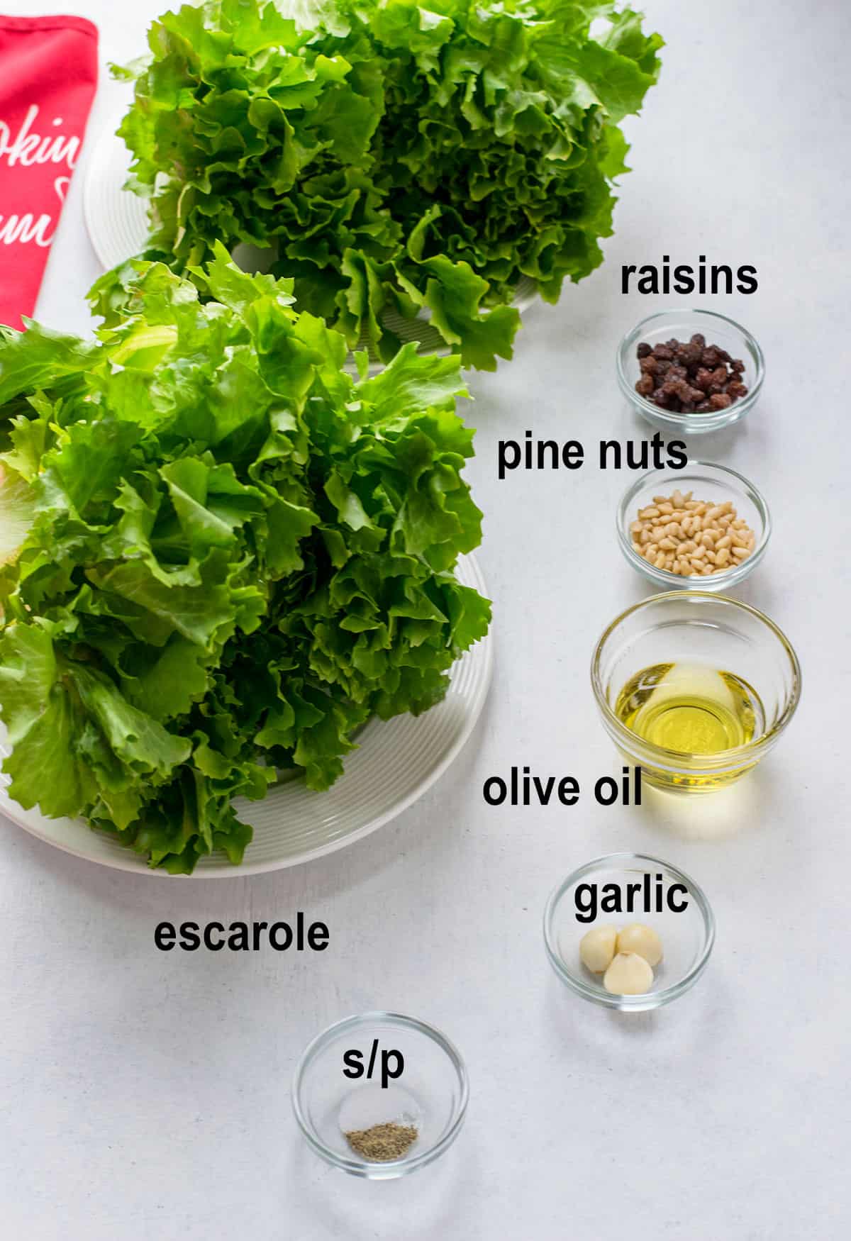 escarole lettuce, raisins, pine nuts, olive oil, garlic, salt, pepper