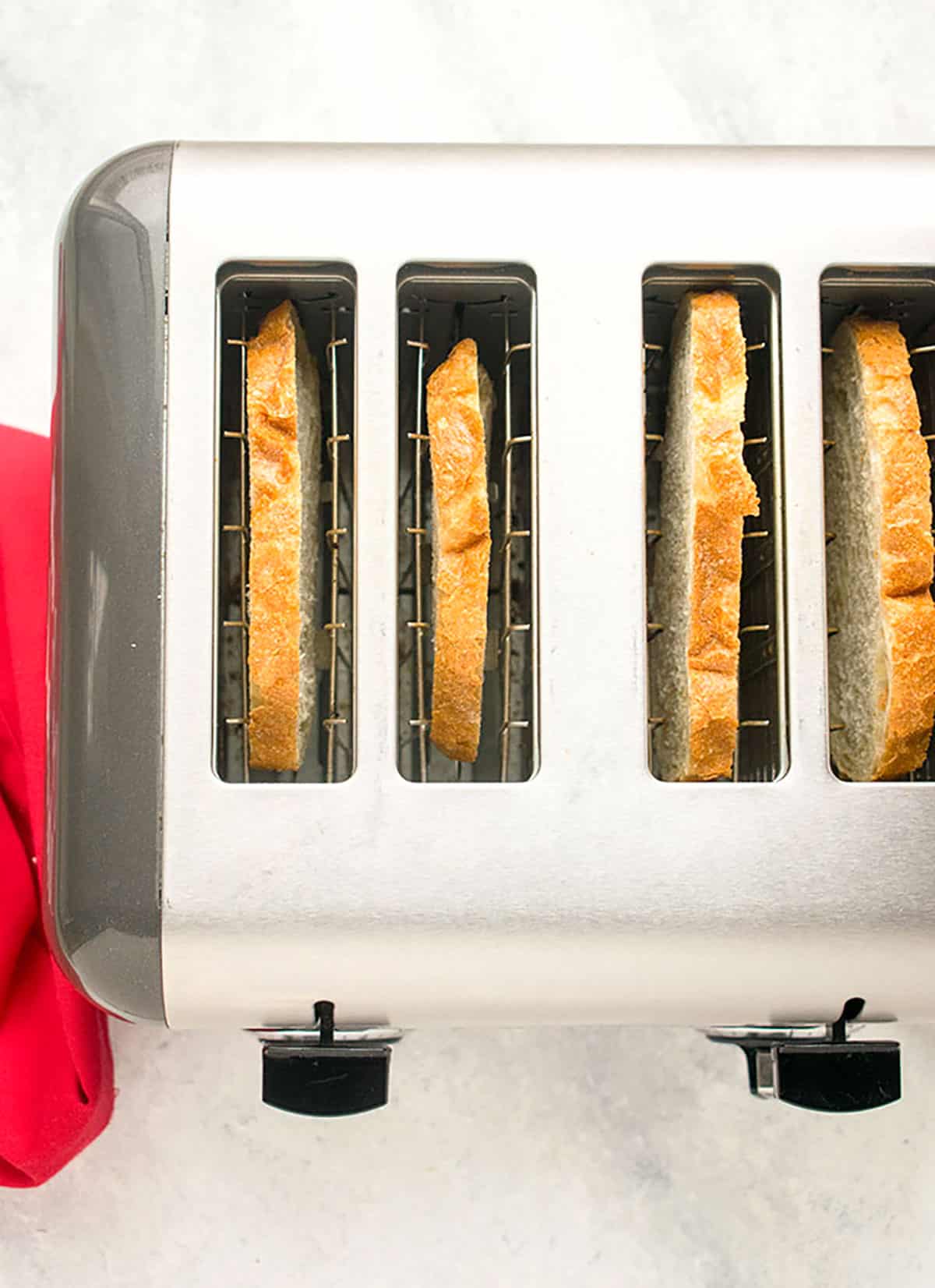 overhead view of toaster with four slices of bread inside
