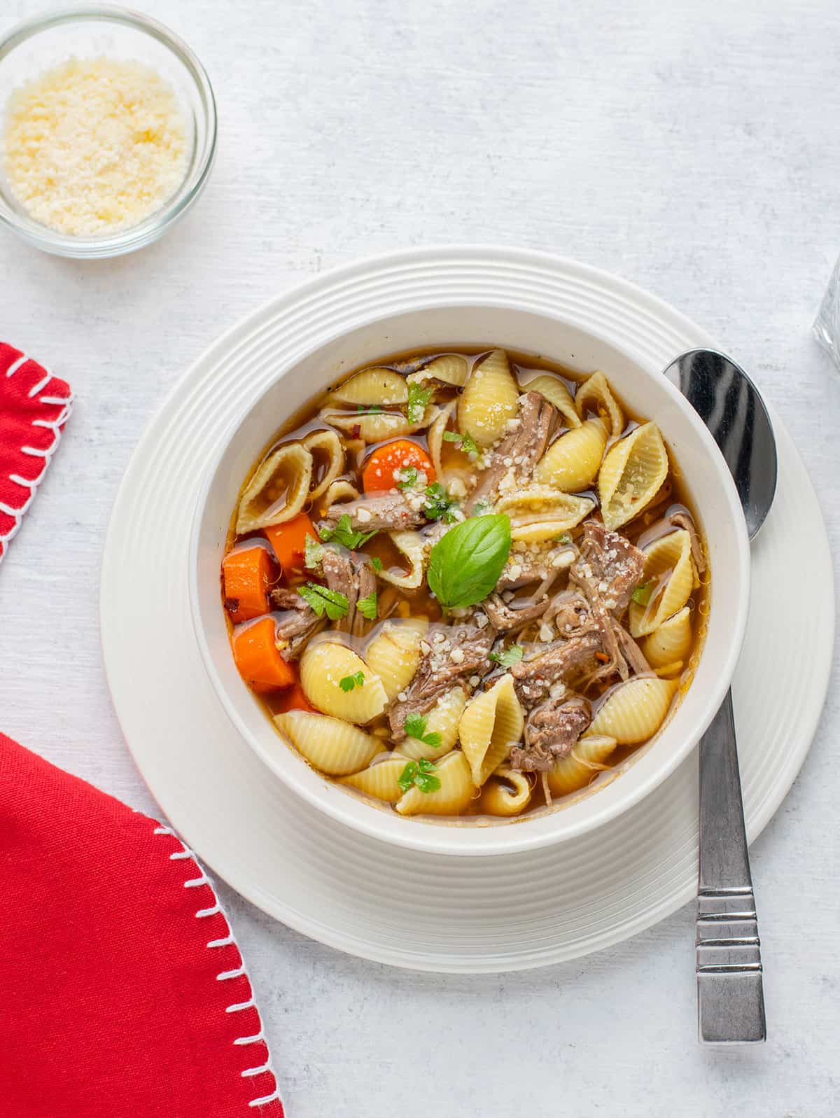 bowl of beef soup with pasta shells